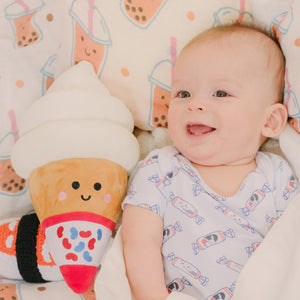 baby laying down with the wee bean ice cream plushie