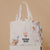 The  Wee Bean eco-friendly canvas reusable tote bag in Boba Bae with dolls and swaddle matching