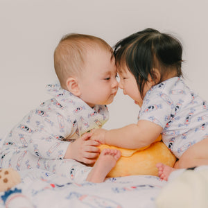 cute baby kissing playing in the wee bean organic bamboo sleepwear zipper romper in bunny candy