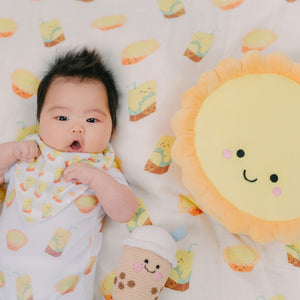 cute baby laying with the wee bean egg tart plushie toy
