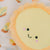 the wee bean plushie pillow snuggle buddy in egg tart top angle view