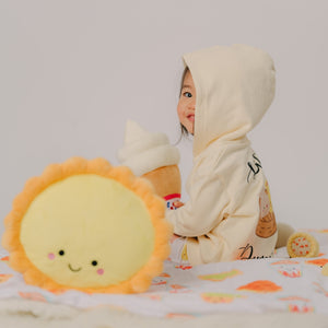 cute toddler sitting with the wee bean egg tart plushie toy