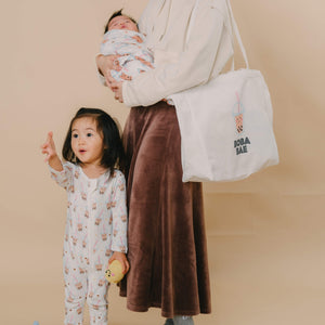 Child in matching Boba zip romper sleepwear with mommy in matching The  Wee Bean eco-friendly canvas reusable tote bag in Boba Bae 