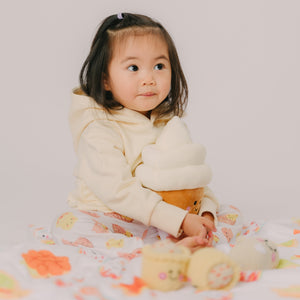 cute girl sitting holding the wee bean ice cream plushie