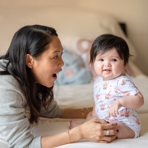 mommy playing with baby in the wee bean boba onesie