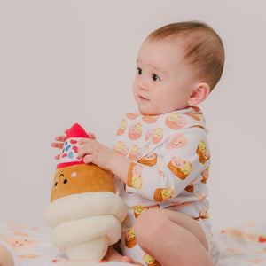 cute baby wearing the wee bean dim sum bib playing with dolls