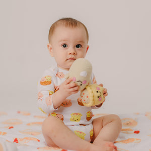 cute baby holding onto the wee bean rattle dolls