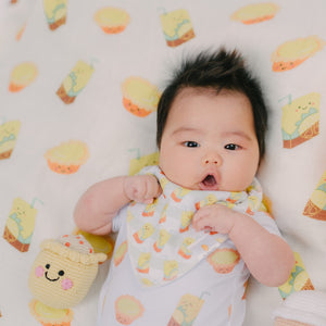 cute baby laying on the wee bean lemon tea and egg tart organic cotton bamboo swaddle