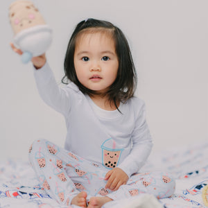 cute girl holding boba doll in boba PJs