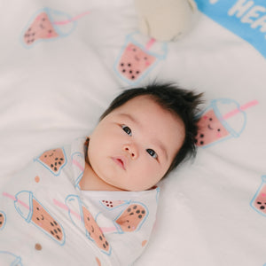 cute baby laying on boba milestone blanket 