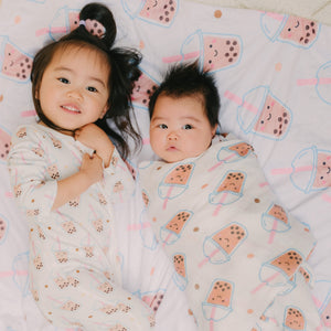 siblings laying down in boba prints