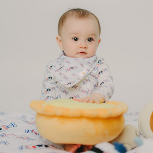 cute baby wearing the wee bean bunny candy bib and playing with plushie