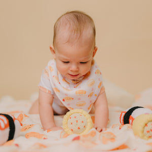 cute baby drooling wearing the wee bean's bakery buns bib and onesie