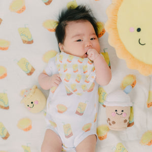 cute baby laying down in the wee bean lemon tea and egg tart onesie