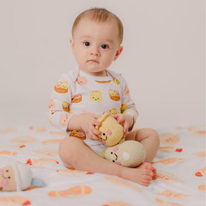 cute baby sitting on the wee bean bakery buns minky blanket playing with toys