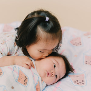  sister kissing baby on boba minky blanket