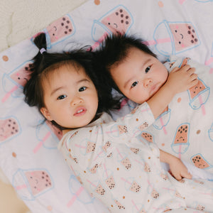 sisters hugging on boba minky blanket